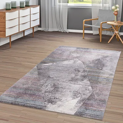 A modern living room with a wooden floor, a dresser, a chair, a small table, and a rug.