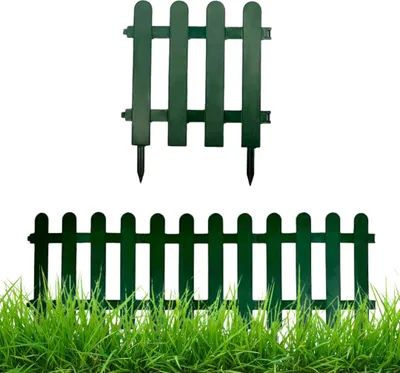 Two dark green plastic fence elements are shown against a white background, with a third element partially visible in the foreground, embedded in green grass.