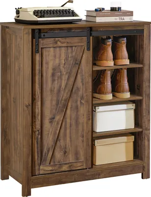 A wooden sideboard with a sliding door and open shelves displaying shoes and boxes.