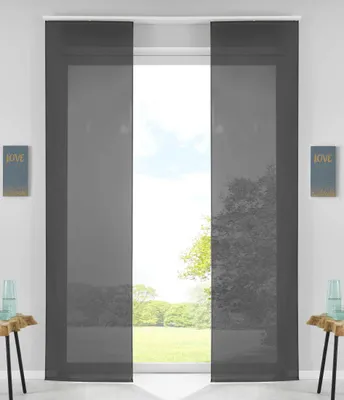 Two dark gray panel curtains are shown hanging in front of a window with a view of trees and a lawn.