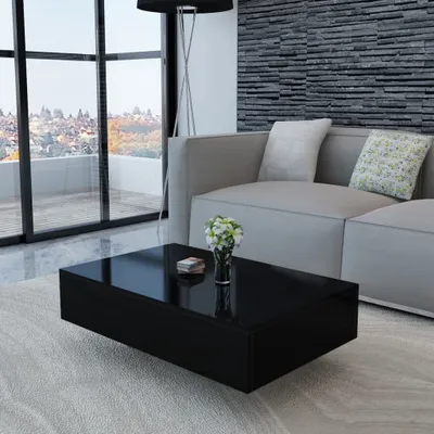 A modern living room with a black coffee table in the foreground, a sofa, and a large window with a view.