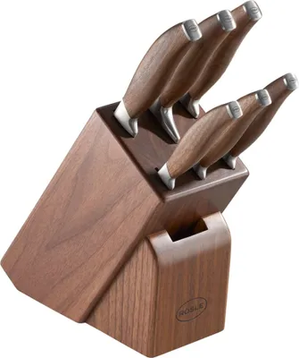 A set of kitchen knives in a wooden block.