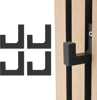 Four black hooks are arranged on a white background, and one hook is attached to a wooden panel with black strips.