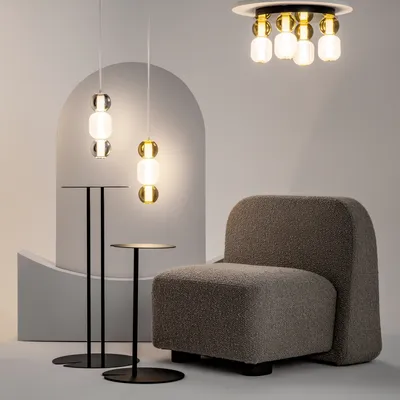 A modern interior scene featuring a chair, side tables, and pendant lights.