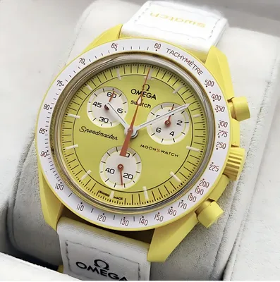 A close-up shot of a yellow and white Omega x Swatch watch, presented in a box.