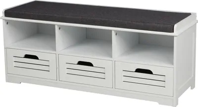 A white shoe bench with a dark gray cushion on top, featuring three open shelves and three drawers with slatted fronts.