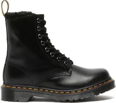 A black Dr. Martens boot with yellow stitching and a white sole.