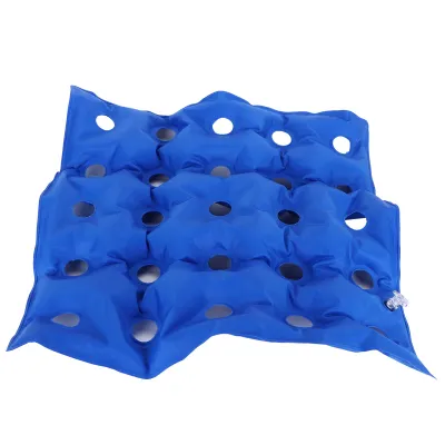 A blue inflatable cushion with multiple circular openings, shown against a white background.