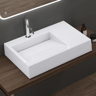 A modern white sink with a chrome faucet is mounted on a wooden countertop.