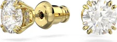 A pair of gold-colored stud earrings with clear gemstones, shown against a white background.