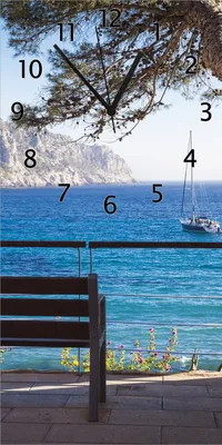 Produktbild von Wallario Design Wanduhr bedruckt, Größe 30 x 60 cm, Motiv: Einsame Bank am Meer - Spanien im Sommer