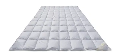 A white down comforter is laid out flat on a white background.
