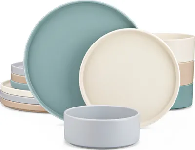 A collection of ceramic plates and bowls in various muted colors.