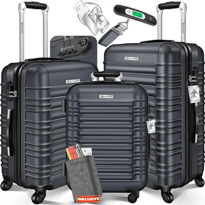 A set of three dark gray suitcases of varying sizes, along with travel accessories like a luggage scale, luggage tag, and passport holder with tickets.