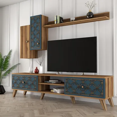 A modern TV stand and wall unit with decorative elements, set against a white paneled wall.