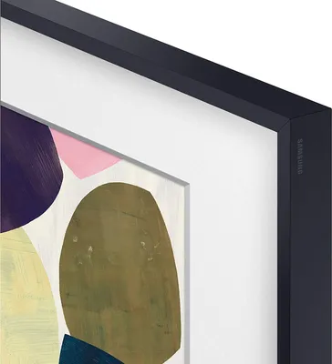 A close-up view of a Samsung Frame TV with abstract art displayed on its screen, framed by a black bezel.