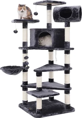 A multi-level cat tree with various platforms, perches, and a hammock, featuring scratching posts and hanging toys. Two cats are visible on the structure.