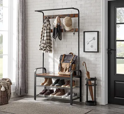 An entryway with a coat rack and shoe storage unit.