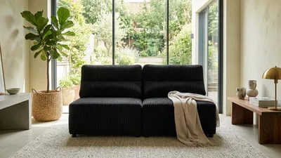 Produktbild von Schlafsofa KIMO 2 Idylla – mit Schlaffunktion, Cord in Schwarz, Family Meble, KI-generiertes Bild