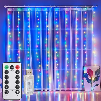 A set of LED curtain lights is displayed hanging on a window with sheer white curtains. A remote control and USB connector are shown in the foreground.