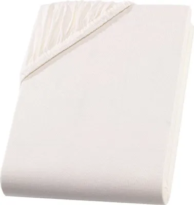 A folded cream-colored fitted sheet is shown against a white background.