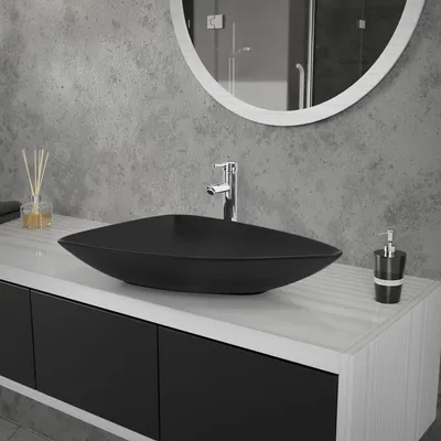A modern bathroom sink with a black matte finish on a white countertop.