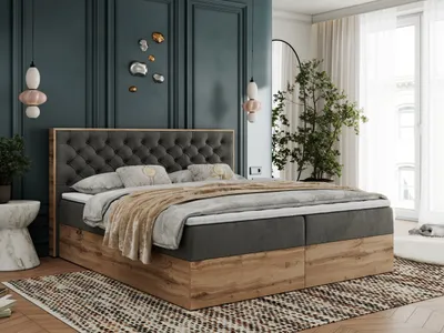 A bedroom scene featuring a large boxspring bed.