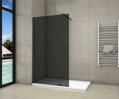 A modern bathroom with a walk-in shower, towel rack, and a large window overlooking a tropical scene.