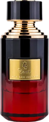 A perfume bottle with a black and gold cap and a red glass body.