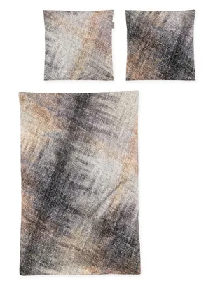 A flat lay of bedding items with a textured, abstract pattern.