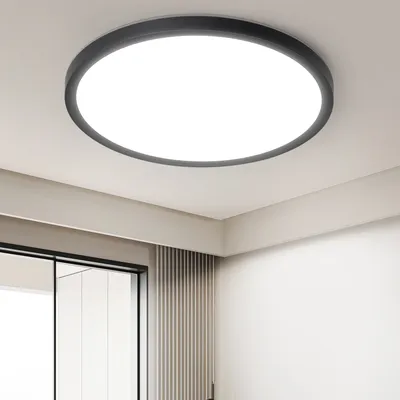 A modern, round LED ceiling light fixture mounted on a white ceiling.