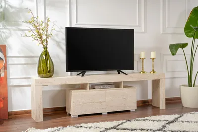 A TV stand with a TV on it, in a living room setting.