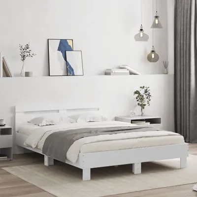 A white bed frame with bedding in a bedroom setting.