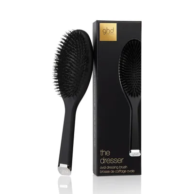 A black oval hairbrush and its packaging are displayed against a white background.