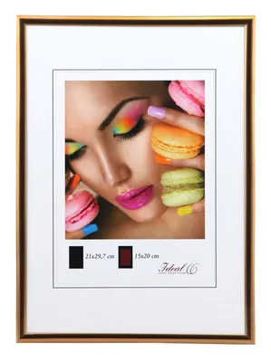 A framed picture of a woman's face with macarons and colorful makeup.