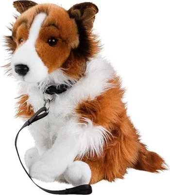 A plush toy dog sitting down with a leash attached.