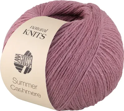 A ball of pink yarn with a beige label.