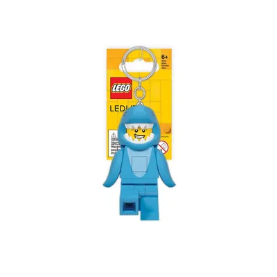 A LEGO Classic keychain with a shark design and LED light function, presented on a yellow backing card.