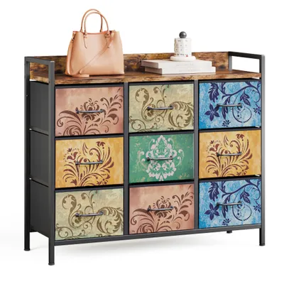 A dresser with 9 drawers, each with a different floral pattern, sits on a white background. A handbag and books are on top of the dresser.
