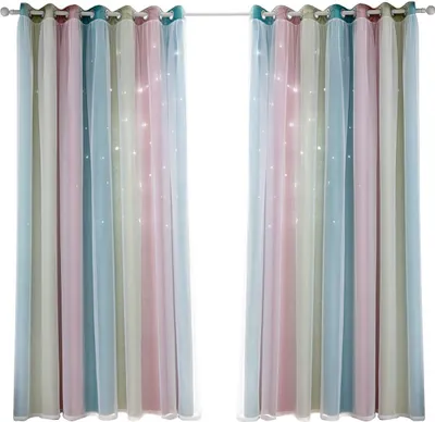 Two colorful curtains with star cutouts hanging from a curtain rod.