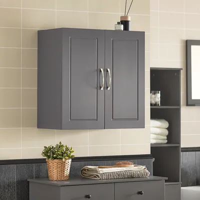 A gray cabinet with two doors is mounted on a tiled wall above a gray cabinet with drawers.