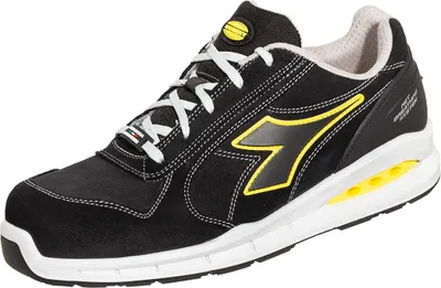 A studio shot of a black Diadora athletic shoe with yellow accents.