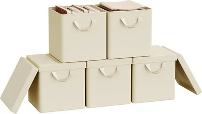 A set of five cream-colored storage boxes, some stacked and some with lids open, against a white background.