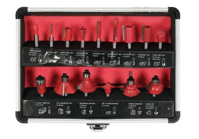 A set of router bits in a black and silver case with a red interior.