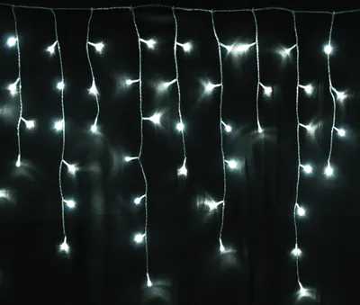 A string of white LED lights hanging against a black background.