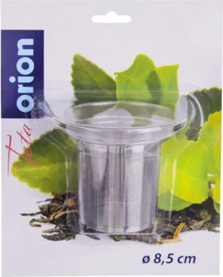 A tea strainer in its packaging, with green leaves and tea leaves as background.