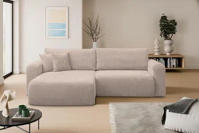 A modern living room with a sectional sofa, coffee table, and artwork.