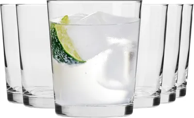A set of clear drinking glasses with ice and lime slices.