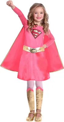 A young girl dressed as Supergirl, posing with her fist raised.