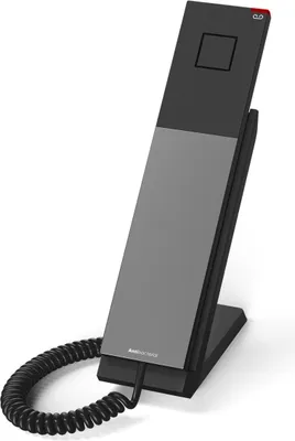 A modern hotel telephone on a stand, with a coiled cord.